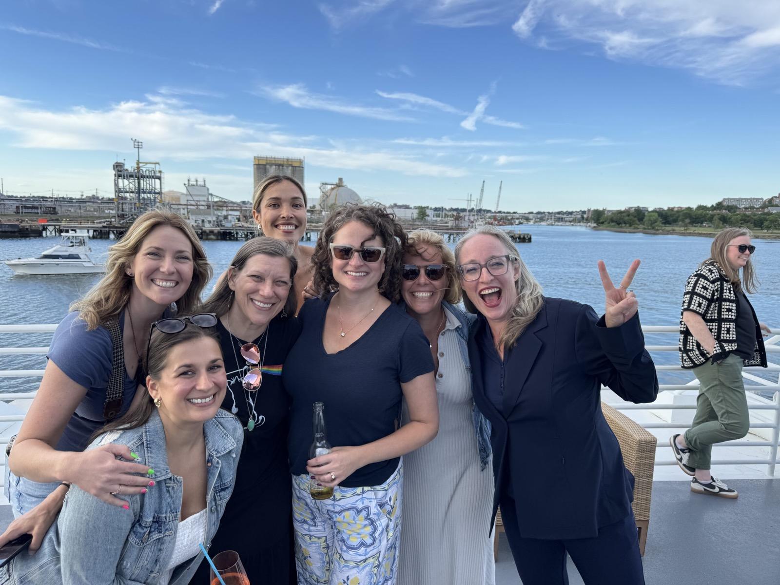 Pixability team members posing on a boat on a sunny day