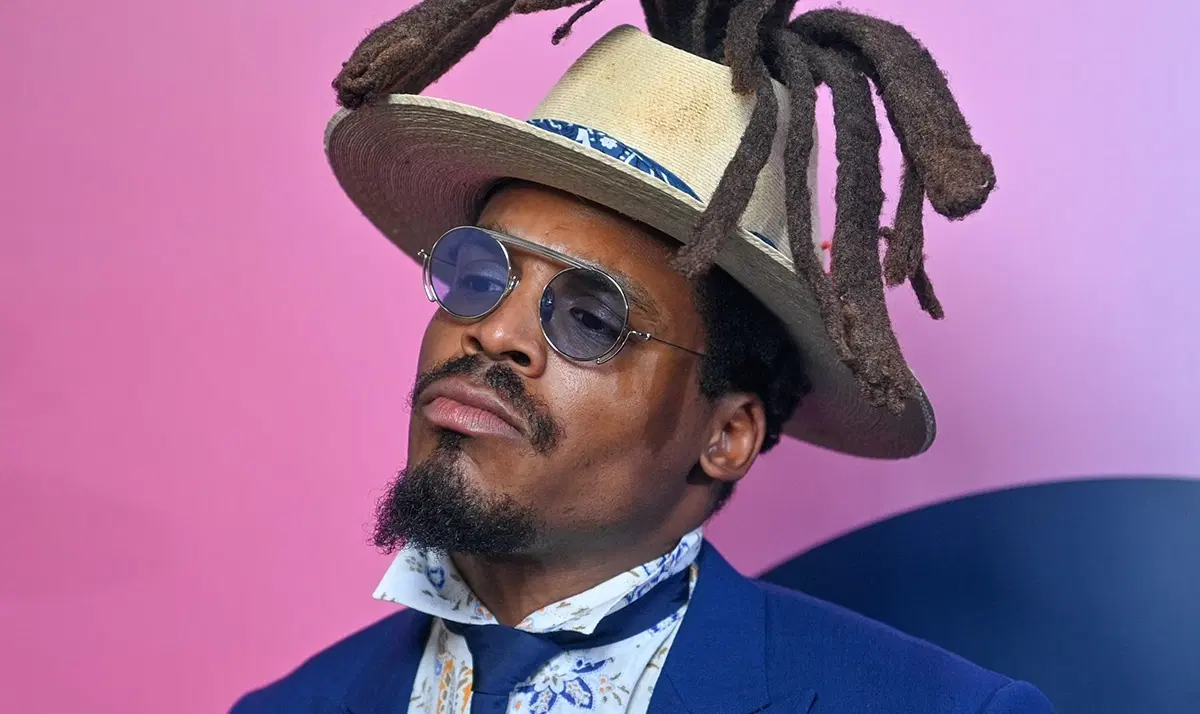 Creator in a wide-brimmed hat and sunglasses
