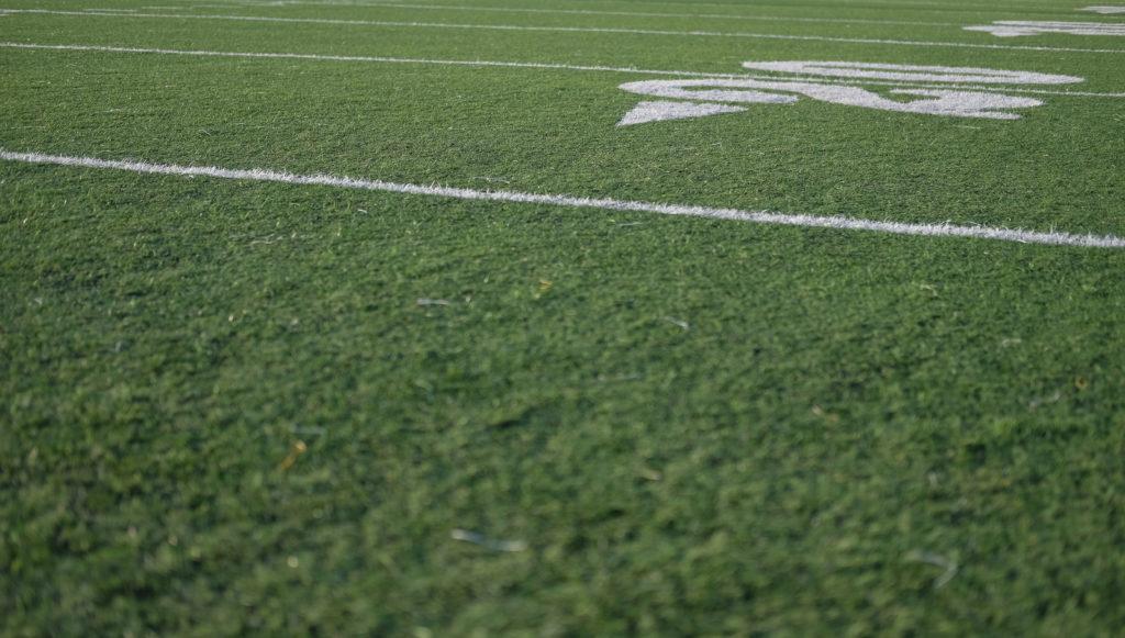 Low angle view across grassy sports field.