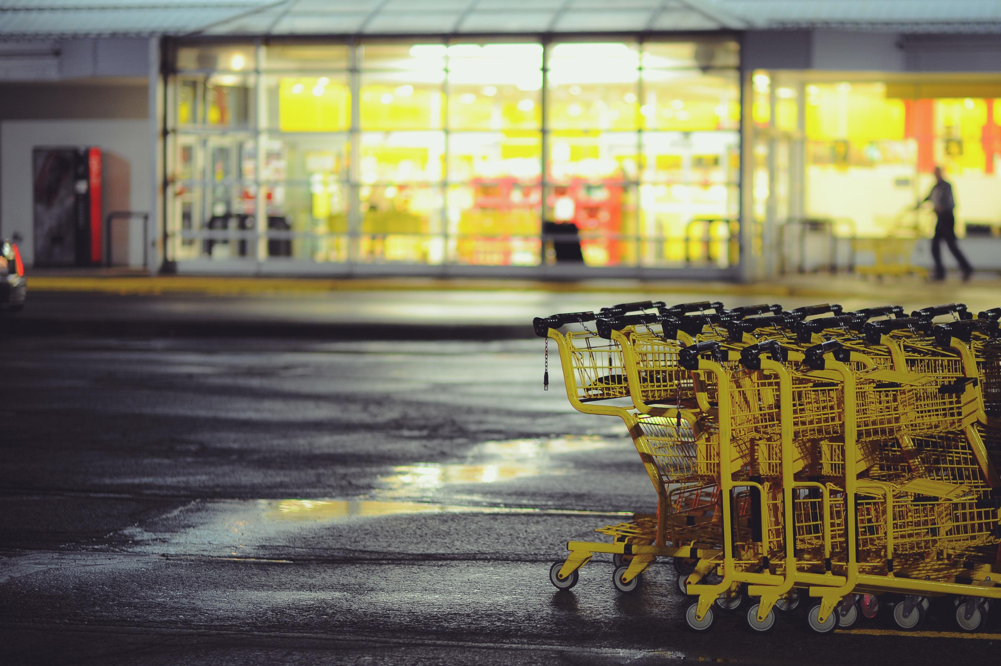 Shopping carts in a parking lot outside of a retail establishment.