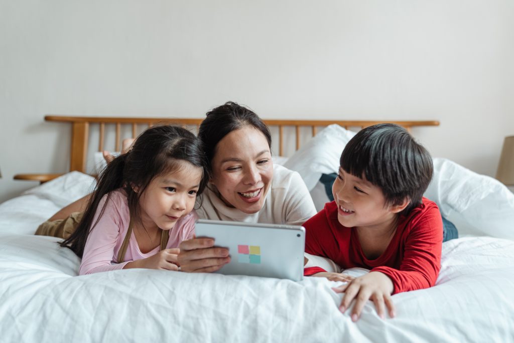 photo of family watching video on a tablet